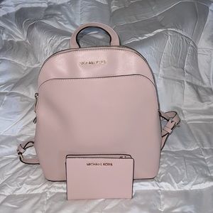 Pink Michael Kors backpack and wallet.